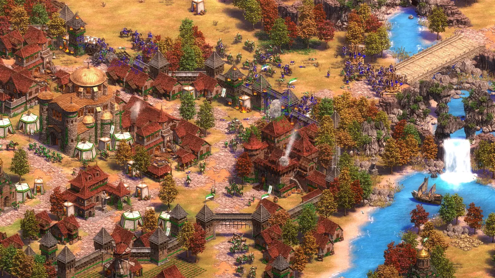 Age of Empires II DE gameplay: a medieval town and army beside a river