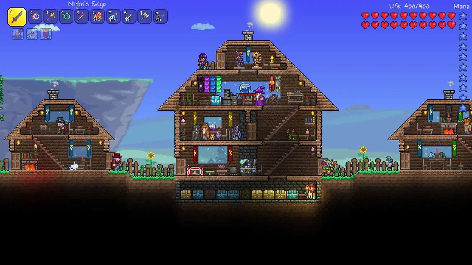 Terraria gameplay: a player built wooden town with NPC houses on a sunny day