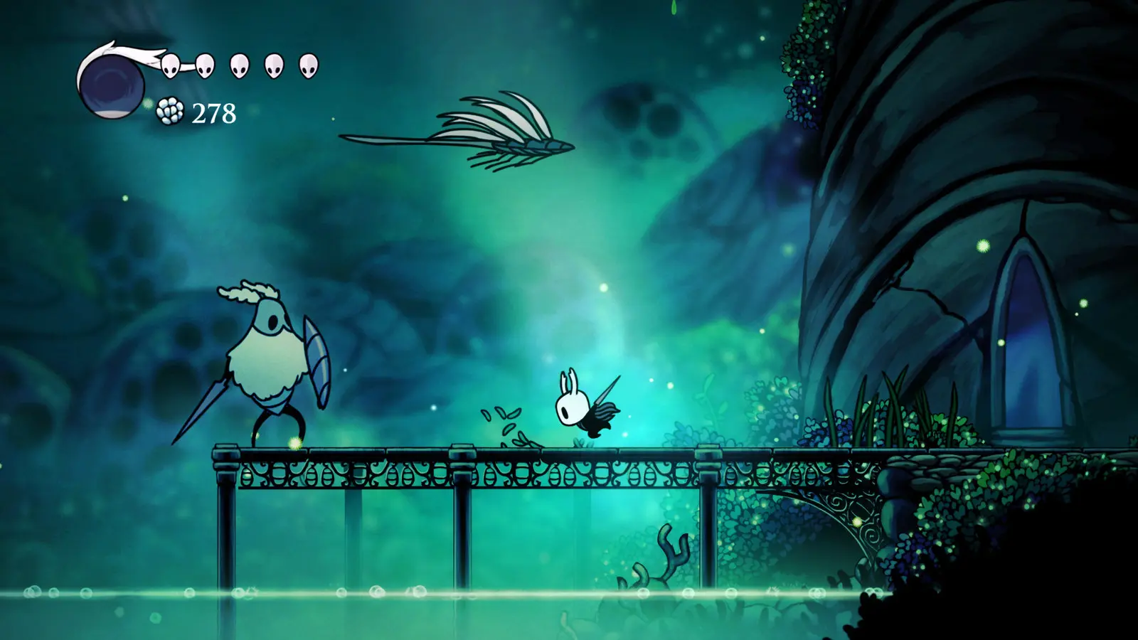 Hollow Knight gameplay: the Knight on a bridge in a glowing green cavern