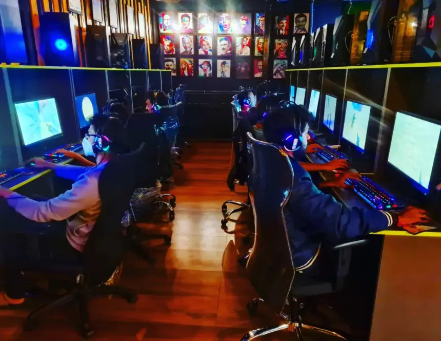 Alpha Esports Gaming Cafe Bangalore large gaming room with rows of players and RGB setups