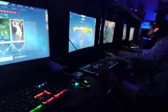 Infinity Gaming Cafe Pune interior gamers playing Valorant on PCs with RGB keyboards