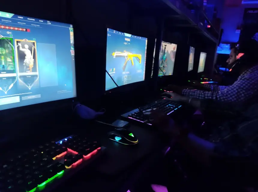 Infinity Gaming Cafe Pune interior gamers playing Valorant on PCs with RGB keyboards