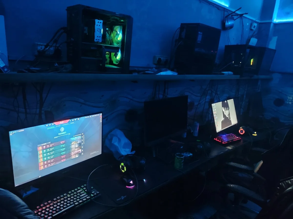 Squad Gaming Internet Cafe Delhi interior with gaming PCs and Valorant on screen