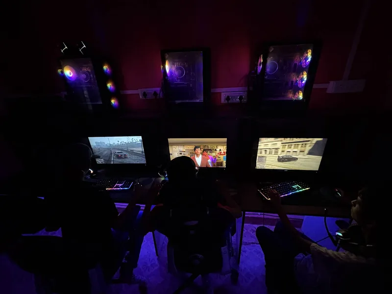 10 Best Gaming Cafes in Pune (2026): Complete Ranked Guide 16 XP Gaming Lounge Viman Nagar Pune gamers playing at RGB lit PCs with wall-mounted towers
