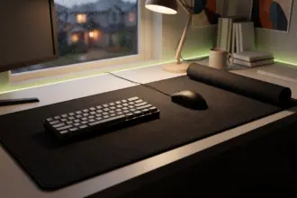 Large cloth desk mat with a stitched edge seen from above, a mouse and keyboard resting on it