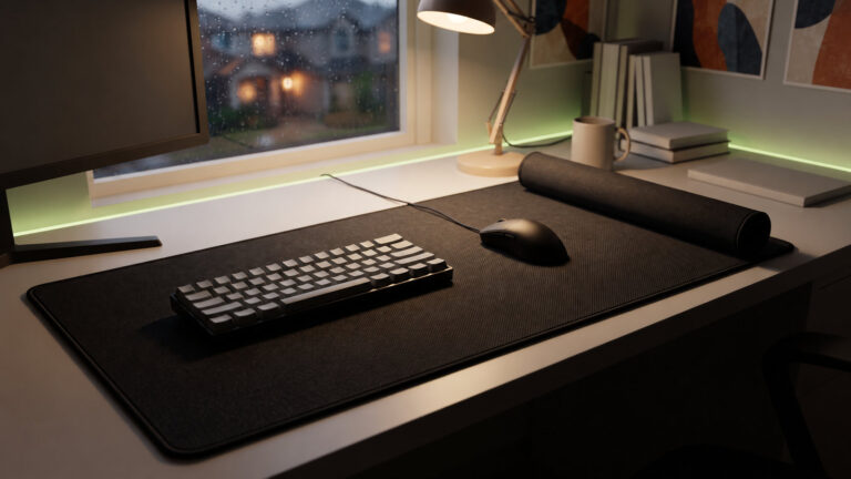 Large cloth desk mat with a stitched edge seen from above, a mouse and keyboard resting on it