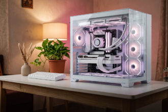White PC cabinet with glass panels showing white fans and sleeved cables on a white desk