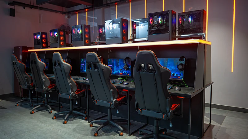 A row of gaming PCs with high-back chairs at Gritty Gaming Lounge and Cafe