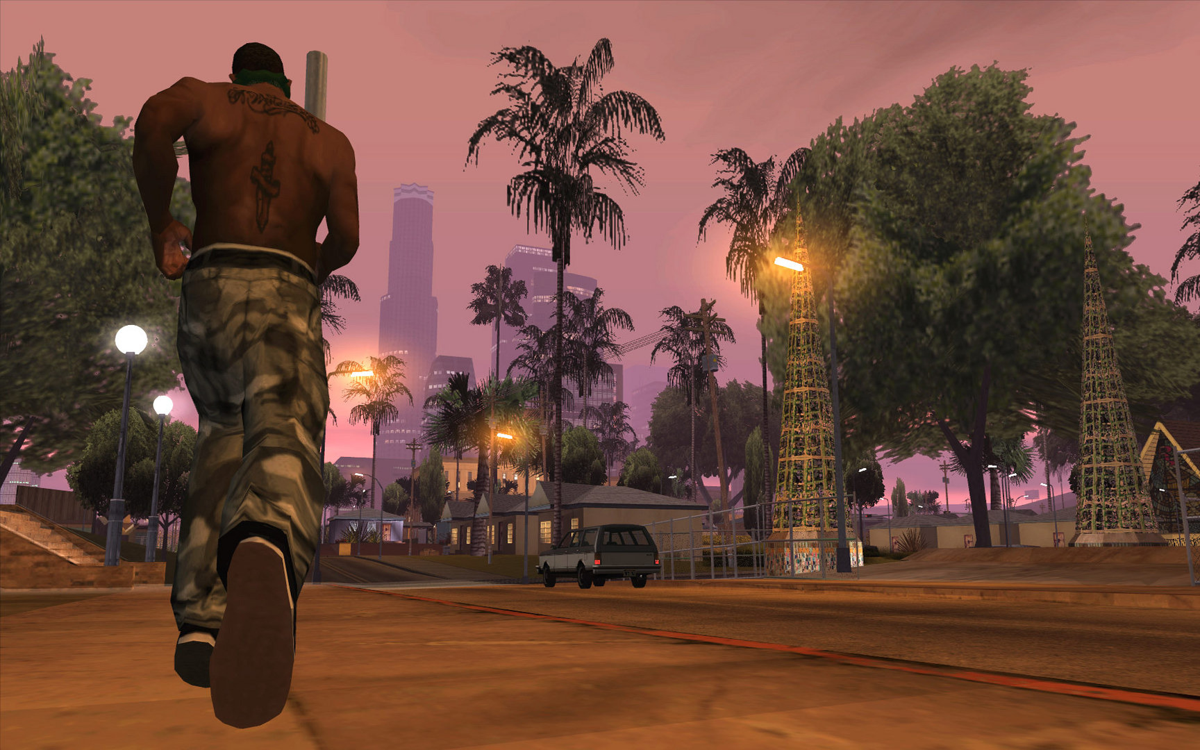 CJ running shirtless with a back tattoo through Los Santos at dusk
