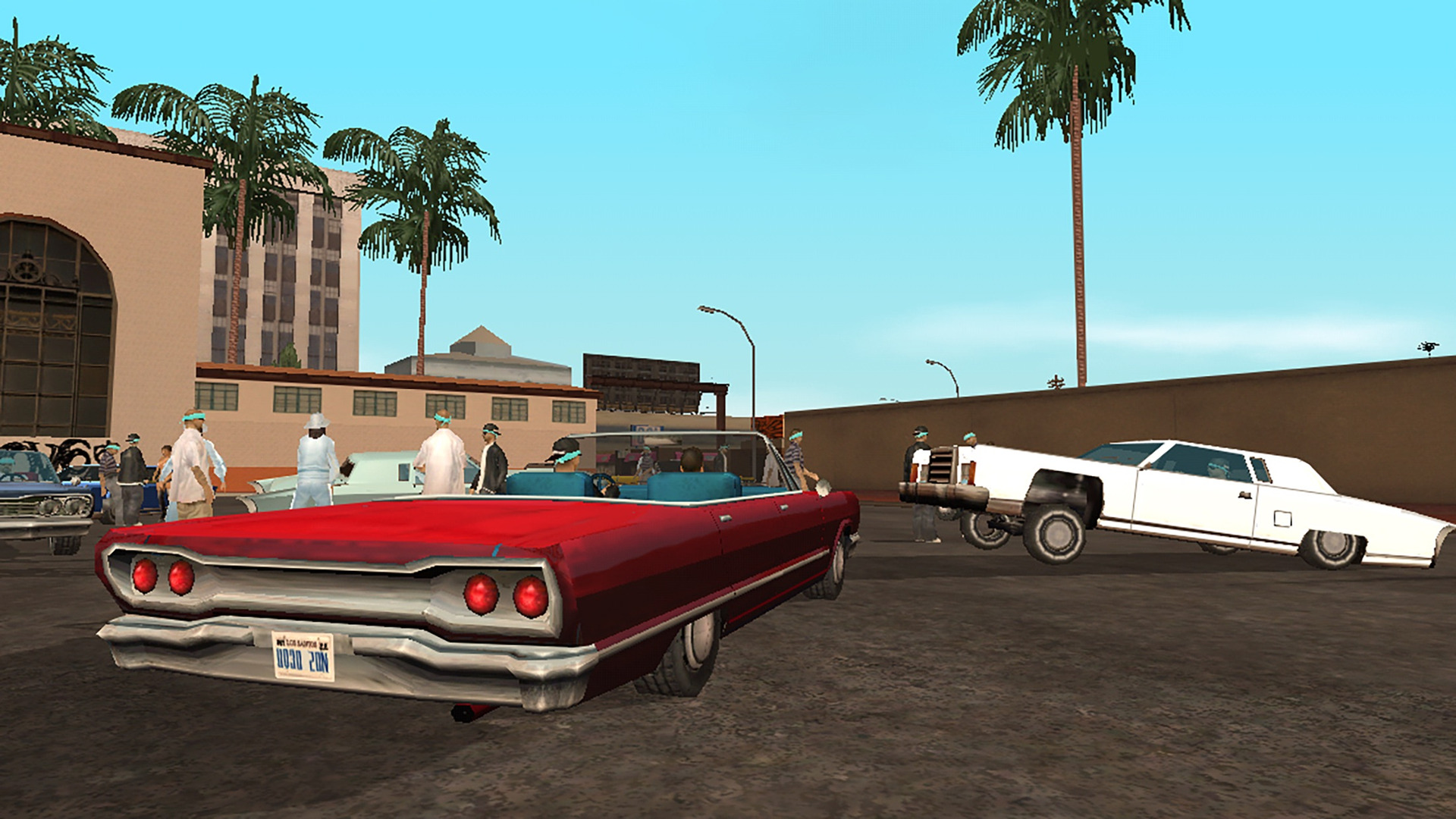 Lowriders parked outside a Los Santos station in the original San Andreas graphics
