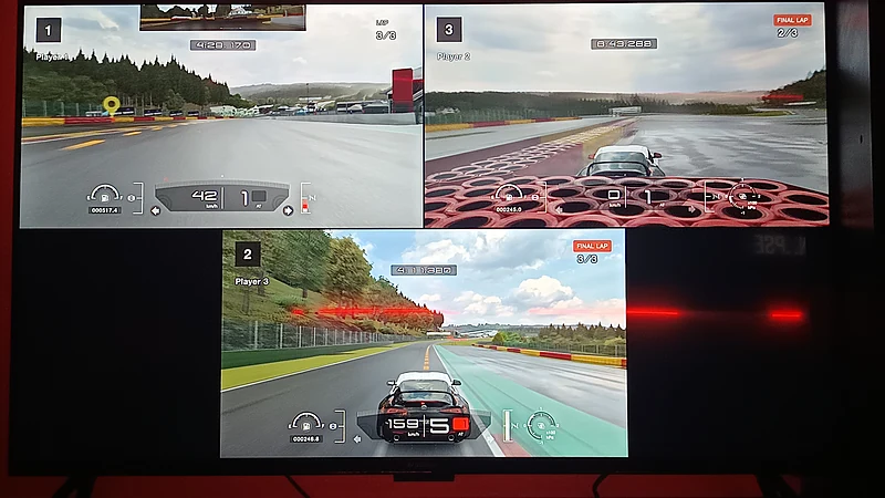 Three racing games running side by side on screens at Synapse Gaming Cafe