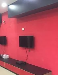 A long room with red walls and wall-mounted TVs at Wonder Game Zone, from a 2018 photo